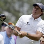 
              Phil Mickelson watches his tee shot on the fourth hole during the third round of the Wells Fargo Championship golf tournament at Quail Hollow Club in Charlotte, N.C., Saturday, May 16, 2015. (AP Photo/Chuck Burton)
            