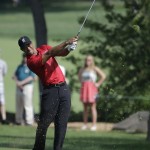 
              Tiger Woods hits to the 14th green during the final round of the Memorial golf tournament Sunday, June 7, 2015, in Dublin, Ohio. (AP Photo/Darron Cummings)
            