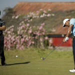 
              Tiger Wood, right, hits his tee shot on the 17th hole as Jason Day, of Australia, looks on during a practice round for the U.S. Open golf tournament at Chambers Bay, Monday, June 15, 2015, in University Place, Wash. (AP Photo/Ted S. Warren)
            