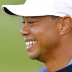 Tiger Woods smiles as he walks on the eighth hole during a practice round at the Phoenix Open golf tournament, Tuesday, Jan. 27, 2015, in Scottsdale, Ariz. (AP Photo/Rick Scuteri)
