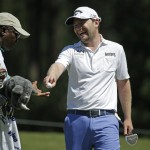               Branden Grace, of South Africa, hands his ball to caddie Zach Rasego, after making a birdie on the seventh hole during the second round of The Players Championship golf tournament Friday, May 8, 2015, in Ponte Vedra Beach, Fla. (AP Photo/Chris O'Meara)
            