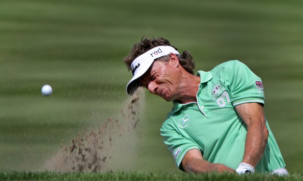 Bernhard Langer hits out of a bunker on 16 during the first round of the Senior Players Championshi...
