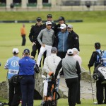 
              From back left at center, United States’ Jimmy Walker, United States’ Rickie Fowler, United States’ Dustin Johnson, United States’ Phil Mickelson and two unidentified people pose for a photograph on Swilcan Bridge, during a practice round at the British Open Golf Championship at the Old Course, St. Andrews, Scotland, Tuesday, July 14, 2015. (AP Photo/David J. Phillip)
            