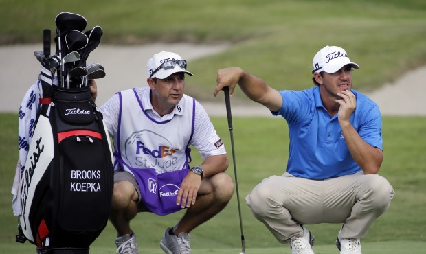Brooks Koepka, right, studies the 16th green with his caddie in the second round of the St. Jude Cl...