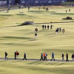 
              People make their way across the 18th hole during the second round of the British Open Golf Championship at the Old Course, St. Andrews, Scotland, Saturday, July 18, 2015. (AP Photo/Alastair Grant)
            