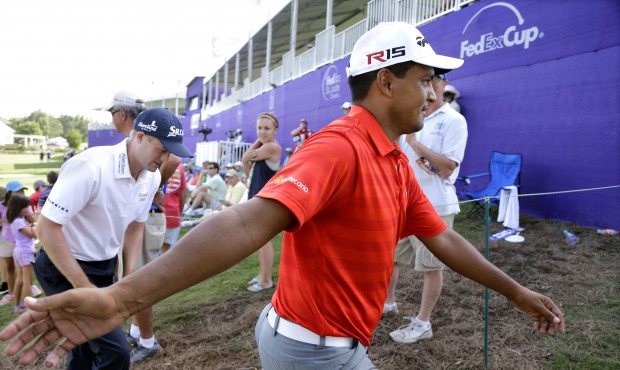 Fabian Gomez, of Argentina, greets fans as he leaves the 18th green during the third round of the S...