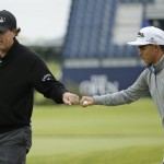 
              United States’ Rickie Fowler, right, bumps his fist with United States’ Phil Mickelson after Mickelson saved par after taking a shot off a road alongside the 17th hole during a practice round at the British Open Golf Championship at the Old Course, St. Andrews, Scotland, Tuesday, July 14, 2015. (AP Photo/David J. Phillip)
            