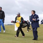 
              United States’ Brooks Koepka, left, his caddie Ricky Elliott, center, and an official walk off the 11tth green after play was suspended due to high wind during the second round of the British Open Golf Championship at the Old Course, St. Andrews, Scotland, Saturday, July 18, 2015. (AP Photo/Alastair Grant)
            