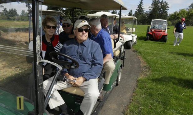 Golfer Jack Nicklaus, front right, and his wife Barbara, left, pause while driving a golf cart, Tue...