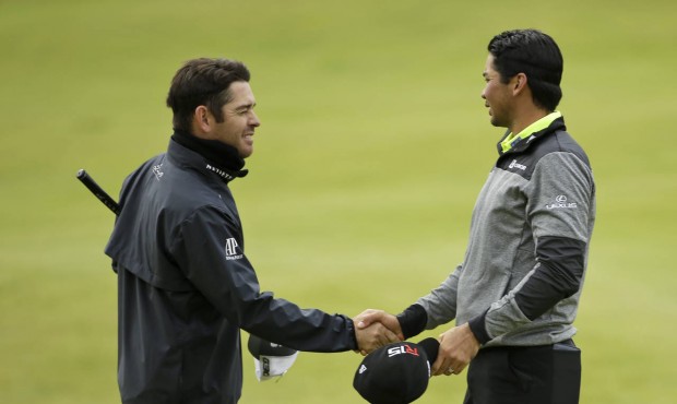 Australia’s Jason Day, right, shakes hands with South Africa’ Louis Oosthuizen on the 1...