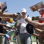 
              Rory McIlroy signs autographs as he walks to the third tee during the pro-am for the Wells Fargo Championship golf tournament at the Quail Hollow Club in Charlotte, N.C., Wednesday, May 13, 2015. (AP Photo/Chuck Burton)
            