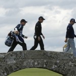 
              England’s Danny Willett, center, and United States’ Gary Woodland cross the Swilcan Bridge on the 18th hole during the second round of the British Open Golf Championship at the Old Course, St. Andrews, Scotland, Friday, July 17, 2015. (AP Photo/Jon Super)
            