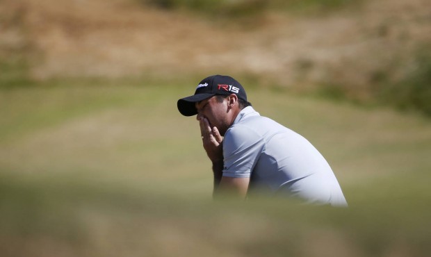 Jason Day, of Australia, reacts after missing a putt on the ninth hole during the third round of th...