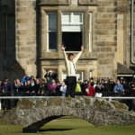 
              England’s Nick Faldo waves to spectators as he stands on the Swilcan Bridge during the second round of the British Open Golf Championship at the Old Course, St. Andrews, Scotland, Friday, July 17, 2015. (AP Photo/Jon Super)
            