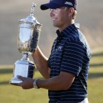 
              Jordan Spieth holds up the trophy after winning the U.S. Open golf tournament at Chambers Bay on Sunday, June 21, 2015 in University Place, Wash. (AP Photo/Lenny Ignelzi)
            