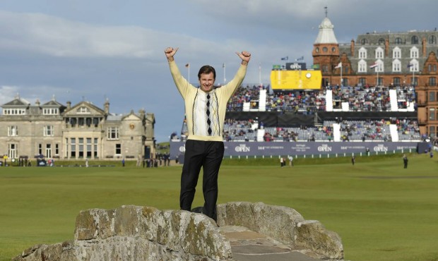 England’s Nick Faldo waves as he poses for photographers on the Swilcan Bridge during the sec...