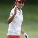 
              Lexi Thompson acknowledges the crowd after her birdie putt on the 10th green during the third round of the Meijer LPGA Classic golf tournament Saturday, July 25, 2015, in Belmont, Mich. (AP Photo/Carlos Osorio)
            