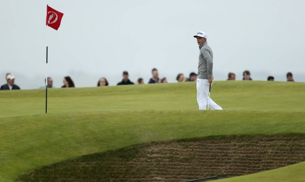 United States’ Rickie Fowler walks next to a bunker on the 11th hole during a practice round ...