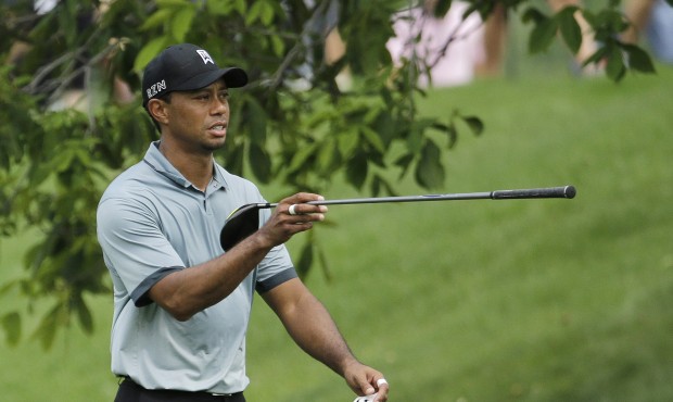 Tiger Woods points in the direction of his drive on the 11th hole during the second round of the Me...