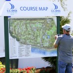 
              Reini Vanderheyd, of University Place, Wash., takes a photo of the course map at Chambers Bay, Thursday, June 11, 2015 in University Place. The golf course will host the U.S. Open golf tournament next week, but spectator entrance areas, the merchandise pavilion, some concessions, and other non-course areas will be open to the public through the weekend. (AP Photo/Ted S. Warren)
            