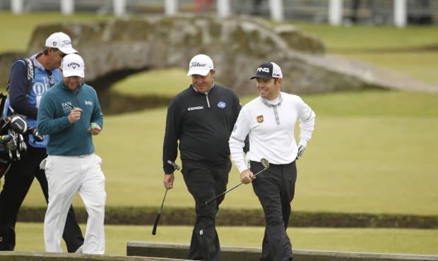 South Africa’s George Coetzee, centre, Louis Oosthuizen, right, and Branden Grace walk toward...