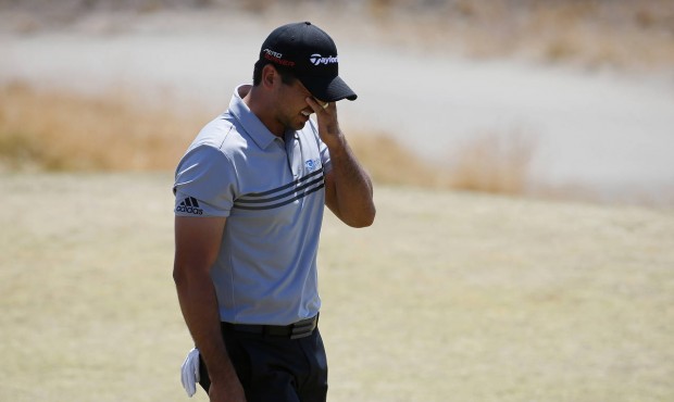 Jason Day, of Australia, wipes his face on the third green during the third round of the U.S. Open ...