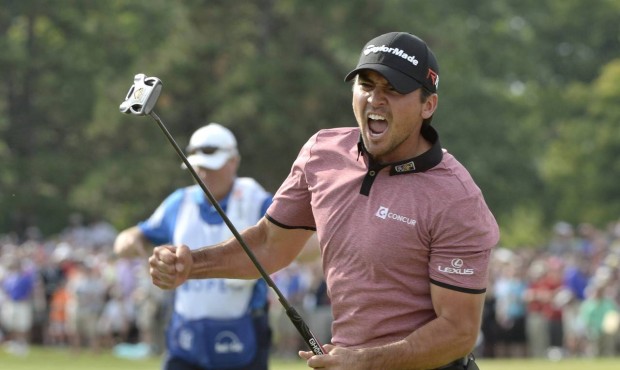 Jason Day celebrates after sinking a birdie putt on the 18th during final-round action at the Canad...
