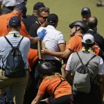 
              Jason Day, of Australia, is helped by emergency personnel after falling down on the ninth hole during the second round of the U.S. Open golf tournament at Chambers Bay on Friday, June 19, 2015 in University Place, Wash. (AP Photo/Ted S. Warren)
            