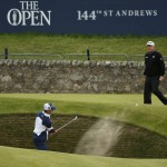 
              United States’ Billy Horschel plays out of a bunker on hole 17 as United States’ Mark Calcavecchia, back right, looks on during a practice round at the British Open Golf Championship at the Old Course, St. Andrews, Scotland, Wednesday, July 15, 2015. (AP Photo/Jon Super)
            