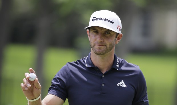 Dustin Johnson reacts after making a birdie on the second hold during the final round of the Memori...