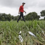 
              Cameron Percy walks by dead minnows on the 11th fairway during the second round of the Byron Nelson golf tournament, Friday, May 29, 2015, in Irving, Texas. Overnight storms flooded parts of the golf course delaying the start of play.(AP Photo/LM Otero)
            
