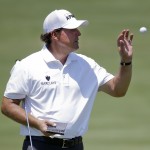 
              Phil Mickelson catches a ball tossed to him by his caddie on the seventh green during the first round of the St. Jude Classic golf tournament Thursday, June 11, 2015, in Memphis, Tenn. Mickelson made par on the hole. (AP Photo/Mark Humphrey)
            