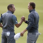 
              Spain’s Sergio Garcia, left, and United States’ Jordan Spieth shake hands on the 18th after completing the third round of the British Open Golf Championship at the Old Course, St. Andrews, Scotland, Sunday, July 19, 2015. (AP Photo/Alastair Grant)
            
