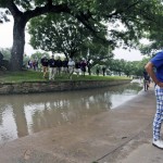 
              Kevin Na looks at the spot his ball landed before bouncing into a rain-swollen drainage culvert adjacent to the 18th fairway where he lost his ball during the second round of the Colonial golf tournament, Friday, May 22, 2015, in Fort Worth, Texas. Na recovered for par on the hole and is the leader at 10-under. (AP Photo/LM Otero)
            