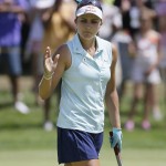 
              Lexi Thompson acknowledges the crowd after her birdie putt on the tenth green during the final round of the Meijer LPGA Classic golf tournament Sunday, July 26, 2015, in Belmont, Mich. (AP Photo/Carlos Osorio)
            