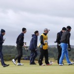 
              United States’ Brooks Koepka, right, and officials walk off the 11th green after play was suspended due to high winds during the second round of the British Open Golf Championship at the Old Course, St. Andrews, Scotland, Saturday, July 18, 2015. (AP Photo/Alastair Grant)
            