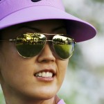
              Michelle Wie, with the golf course reflected in her sunglasses, walks from the tee box on the first hole in the first round of the NW Arkansas Championship LPGA golf tournament at Pinnacle Country Club in Rogers, Ark., Friday, June 26, 2015. (AP Photo/Danny Johnston)
            