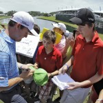 
              Jimmy Walker, left, signs autographs for fans as he comes off the 18th green during a practice round for The Players Championship golf tournament Tuesday, May 5, 2015, in Ponte Vedra Beach, Fla. (AP Photo/Chris O'Meara)
            