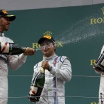 
              Second placed Mercedes driver Lewis Hamilton of Britain, left sprays champagne on the winner Mercedes driver Nico Rosberg of Germany, as third placed Williams driver Felipe Massa of Brazil, center, looks on, following the Formula One Grand Prix race, at the Red Bull Ring in Spielberg, southern Austria, Sunday, June 21, 2015. (AP Photo/Darko Bandic)
            