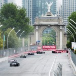
              Indy cars race down past the start line towards the Princes' Gates during the Honda Toronto IndyCar race in Toronto on Sunday, June 14, 2015.  (Nathan Denette(/The Canadian Press via AP) MANDATORY CREDIT
            