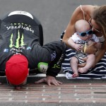 
              Kyle Busch, left, kisses the yard of bricks next to his wife, Samantha, right, and son, Brexton, after winning the NASCAR Xfinity Series auto race at Indianapolis Motor Speedway in Indianapolis, Saturday, July 25, 2015. (AP Photo/Rob Baker)
            