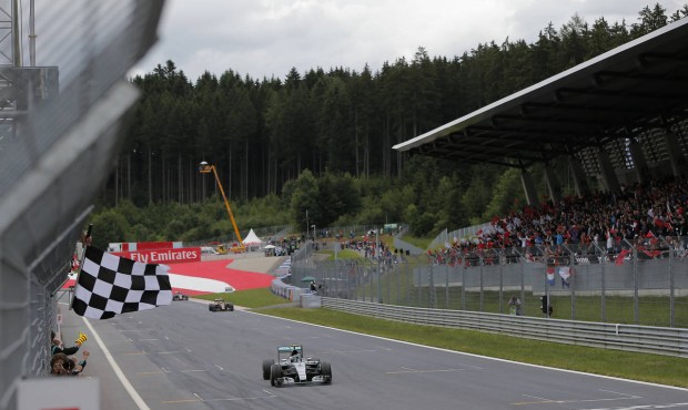 Mercedes driver Nico Rosberg of Germany crosses the finish line to win the Austrian Formula One Gra...