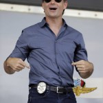 
              NASCAR driver Jeff Gordon points to his badge after he was made a honorary Pittsboro Police Officer following a parade in his honor in Pittsboro, Ind., Thursday, July 23, 2015. Gordon will drive in Sunday's Brickyard 400.  (AP Photo/Michael Conroy)
            