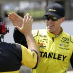 
              Sprint Cup Series driver Carl Edwards (19) celebrates with a member of his crew after winning the pole during qualifying for the NASCAR Brickyard 400 auto race at Indianapolis Motor Speedway in Indianapolis, Saturday, July 25, 2015. (AP Photo/AJ Mast)
            