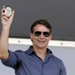 
              NASCAR driver Jeff Gordon holds his badge after he was made a honorary Pittsboro Police Officer following a parade in his honor in Pittsboro, Ind., Thursday, July 23, 2015. Gordon will drive in Sunday's Brickyard 400.  (AP Photo/Michael Conroy)
            