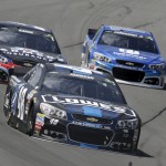 
              Jimmie Johnson (48) leads Dale Earnhardt Jr. (88) and Kasey Kahne (5) through Turn 3 during a NASCAR Sprint Cup Series auto race at Pocono Raceway in Long Pond, Pa., Sunday, June 7, 2015. (AP Photo/Mel Evans)
            