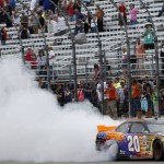 
              Denny Hamlin does a burnout after winning the NASCAR Xfinity series auto race at New Hampshire Motor Speedway on Saturday, July 18, 2015, in Loudon, N.H. (AP Photo/Jim Cole)
            