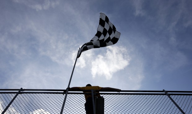 A fan watches a practice session for the Indianapolis 500 auto race at Indianapolis Motor Speedway ...