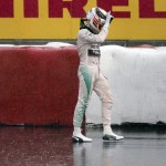 
              In a heavy rain, Mercedes driver Lewis Hamilton, of Great Britain, waves to the crowd as he walks away from his car after crashing into the safety barrier at the hairpin during the afternoon practice session at the Canadian Grand Prix auto race, Friday, June 5, 2015, in Montreal. (Jacques Boissinot/The Canadian Press via AP) MANDATORY CREDIT
            