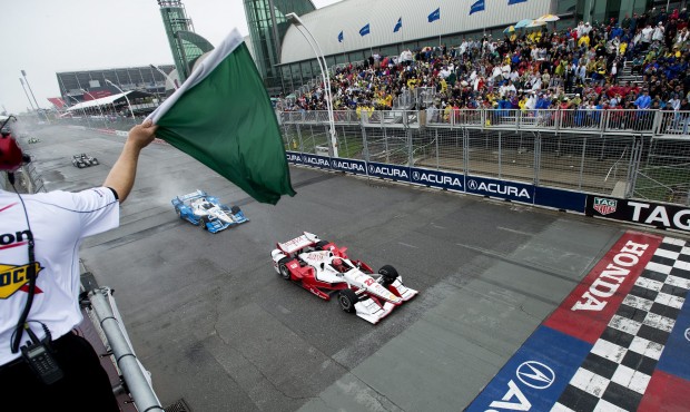 Simon Pagenaud leads Juan Pablo Montoya as they race past the start line during the Honda Toronto I...